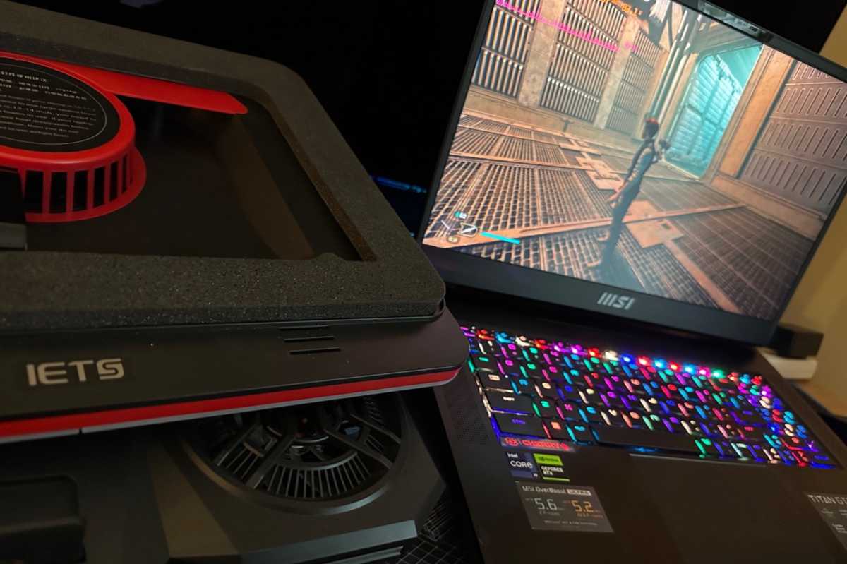 MSI gaming laptop next to IETS laptop cooling pad