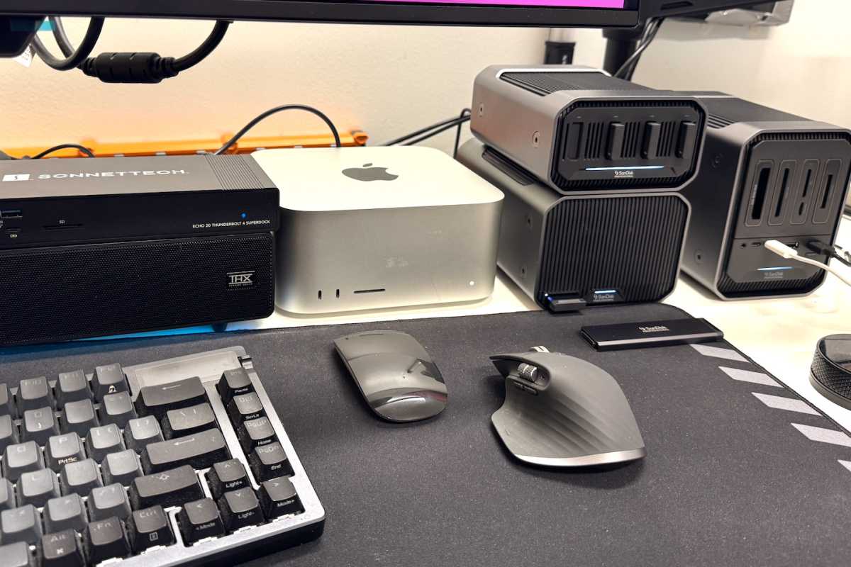 Assortment of accessories and peripherals next to two mice and keyboard