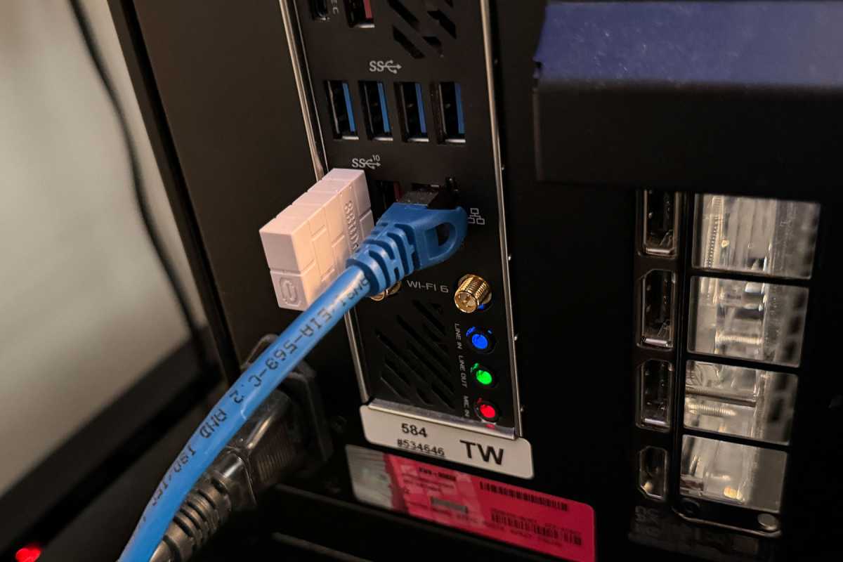 Blue Ethernet cable plugged into the back of a desktop PC