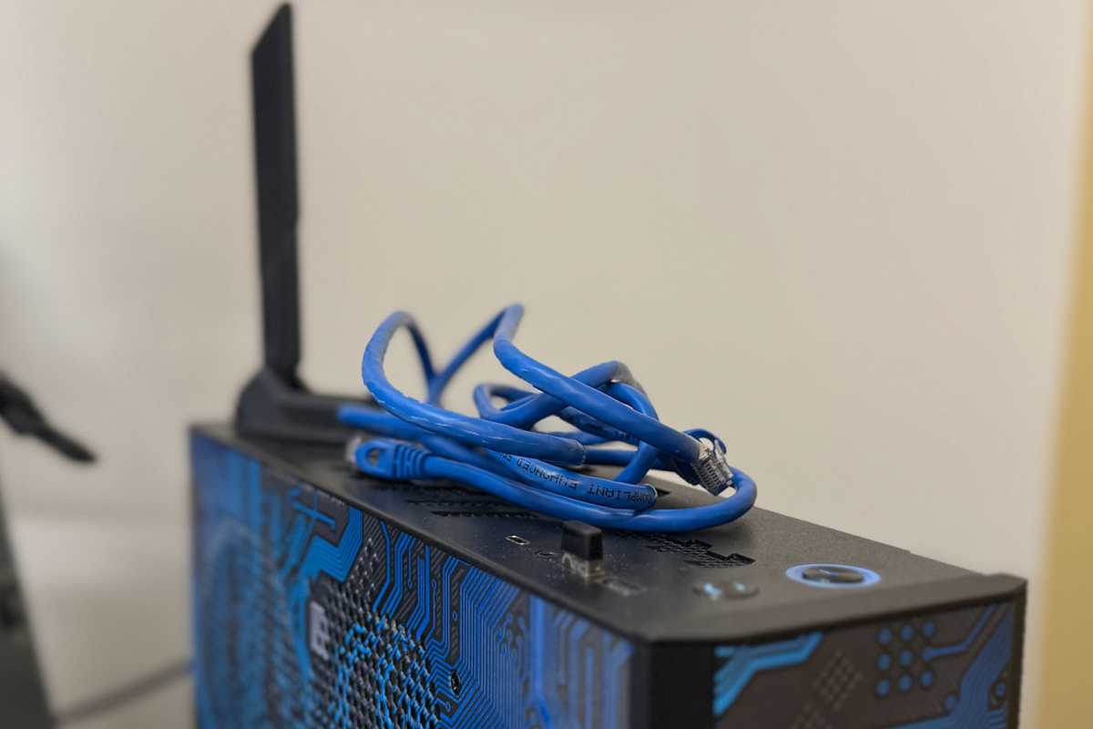 Unplugged blue Ethernet cable sitting on top of desktop PC case